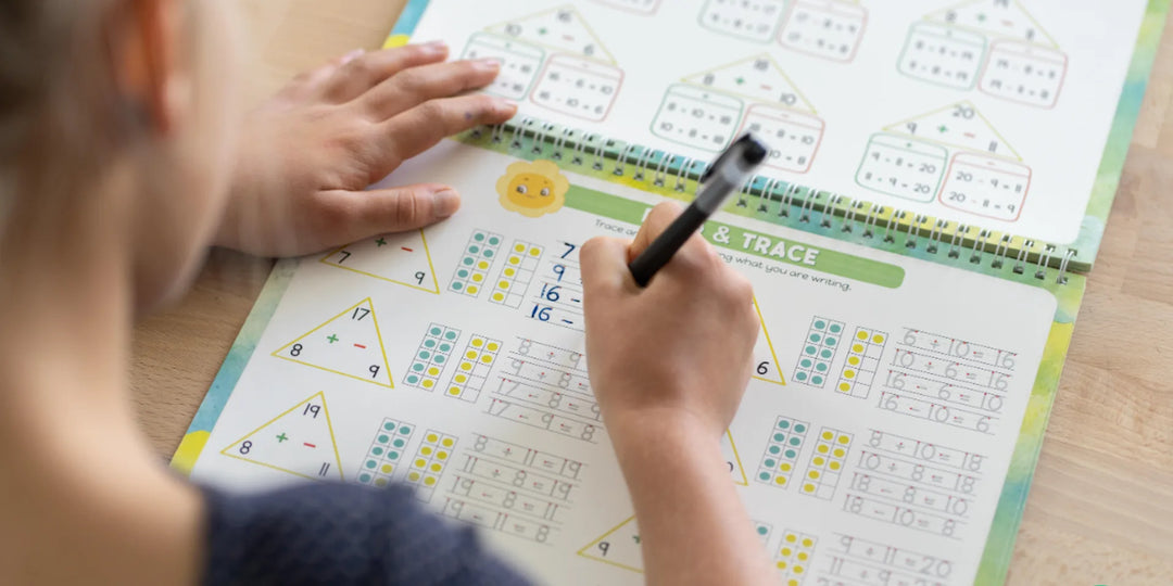 Child practicing cursive handwriting with a Grooved Learning reusable workbook