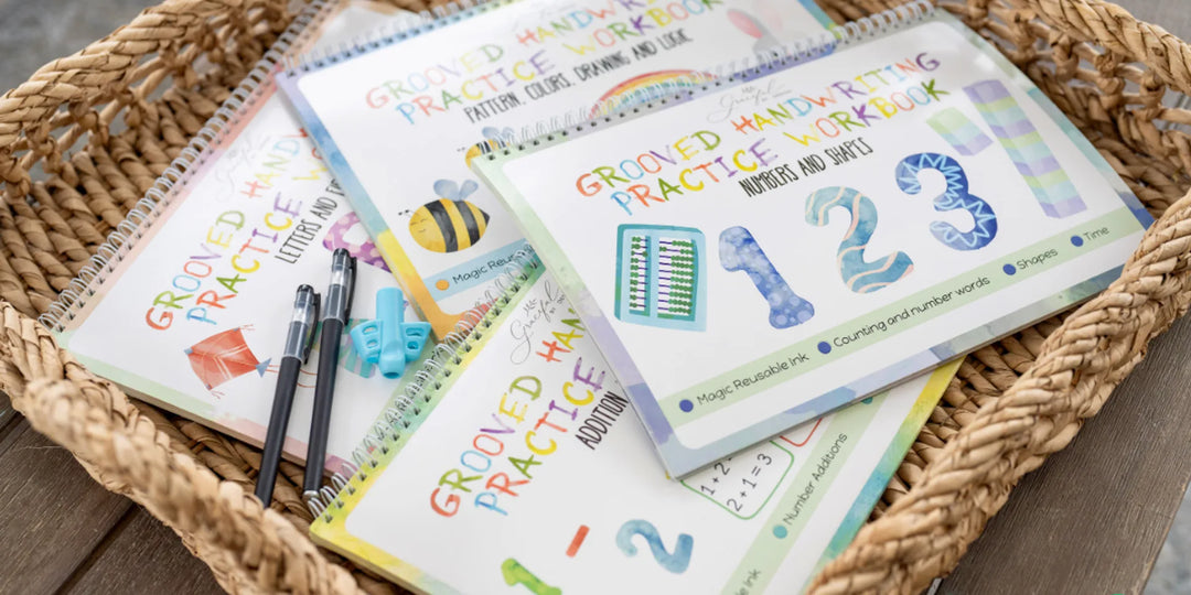 Child practicing handwriting with a reusable grooved workbook and disappearing-ink pen