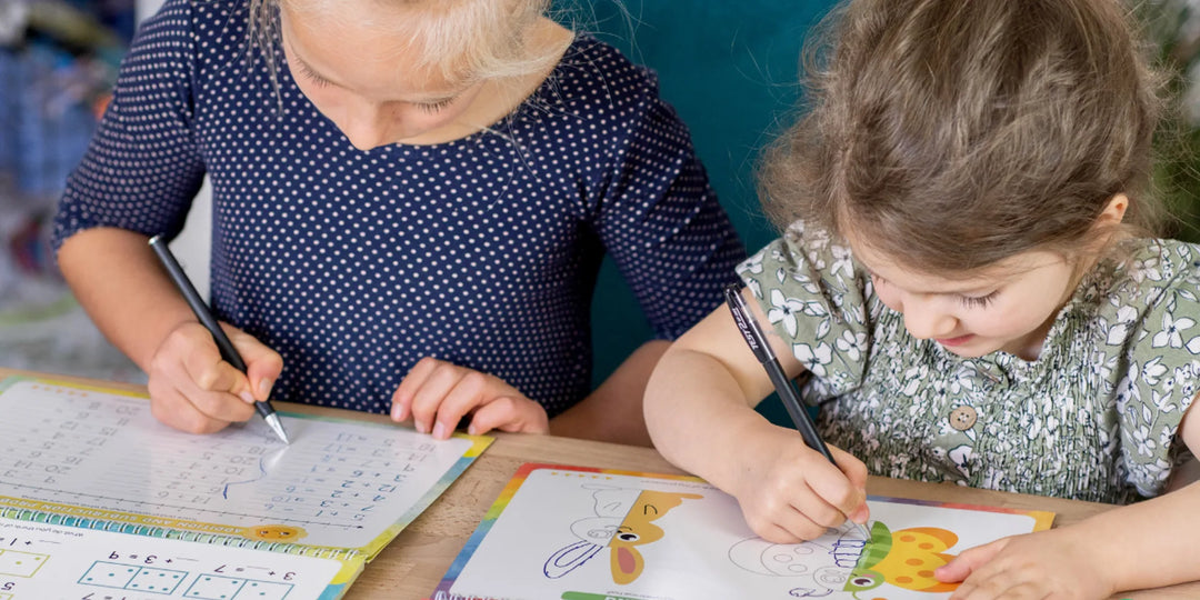 Older child practicing cursive handwriting with a grooved workbook