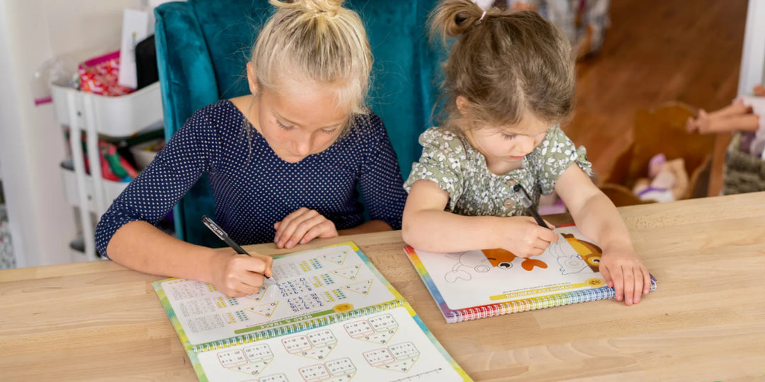 Preschooler tracing letters in a grooved workbook with disappearing ink