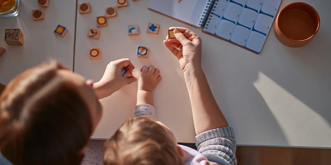Parent and child practicing phonemic awareness activities at home with everyday objects