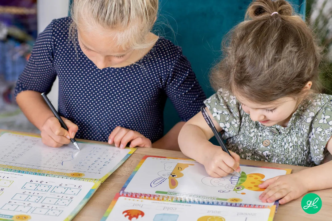 Hand holding a pencil over a number handwriting practice worksheet.