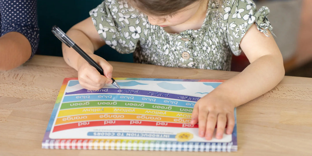 Child practicing kindergarten letter formation with a Grooved Learning reusable grooved handwriting workbook